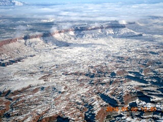 aerial - snow and clouds and canyon