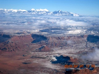 aerial - snow and clouds and canyonlands