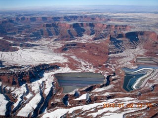 aerial - snowy canyonlands with some clouds