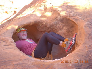 136 8v3. Arches National Park - Devils Garden hike - Adam in hole in the rock - tripod and timer