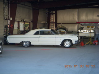 260 8v6. cool old Chevy Impala in hangar