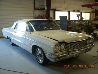 262 8v6. cool old Chevy Impala in hangar