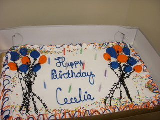 Cecelia and two lit-candle cakes