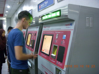 162 99g. Malaysia - Kuala Lumpur food tour - Mathieu buying subway tickets