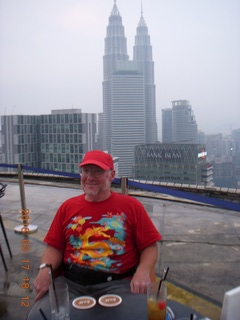 233 99h. Malaysia - Kuala Lumpur - Heli Lounge Bar - Adam sitting - twin Petronas towers