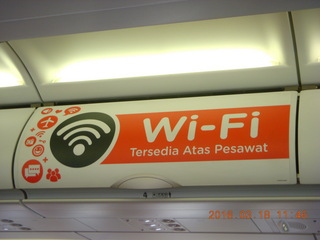 61 99j. Air Asia airplane with ads on the luggage racks
