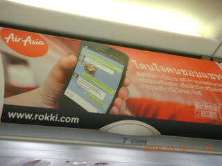62 99j. Air Asia airplane with ads on the luggage racks