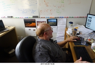 Adam at his desk at work