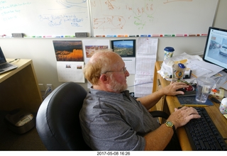 Adam at his desk at work