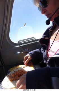 Kim eating her in-flight meal
