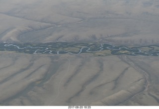 114 9sl. aerial - Riverton to Rock Springs - winding river in wide wash