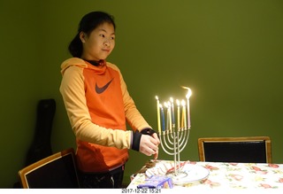 eight lit candles in menorah