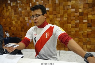 9 a0f. Peru - Lima - hotel receptionist in soccer shirt