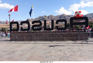 366 a0f. Peru - Cusco square - big sign from behind