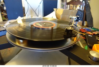 Trasncriptor Skeleton turntable and Vestigal tonearm playing a record