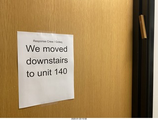 hallway with we-moved-downstairs sign and mezzuzah