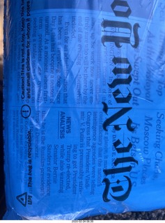 New York Times through blue plastic bag