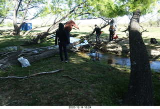 111 a0y. Argentina Eclipse Day - folks crossing the creek on a log