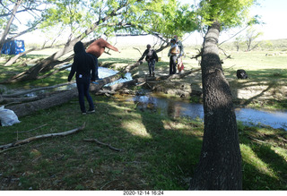 112 a0y. Argentina Eclipse Day - folks crossing the creek on a log