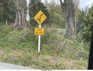 71 a1s. New Zealand - Spellbound Glowworm & Cave Tours - down to the cave - drive on the left sign