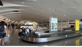 36 a2y. Spain - barcelona to bilbao flight - people sitting on baggage-claim belt