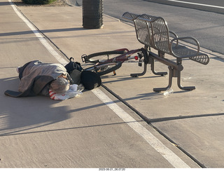 fellow lying on the sidewalk - day of my first ride in my new bike