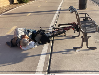 fellow lying on the sidewalk - day of my first ride in my new bike