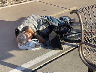 fellow lying on the sidewalk - day of my first ride in my new bike