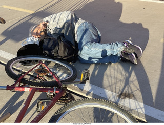 fellow lying on the sidewalk - day of my first ride in my new bike